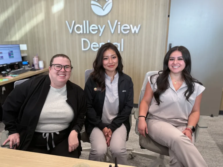 Three women seated at dental office