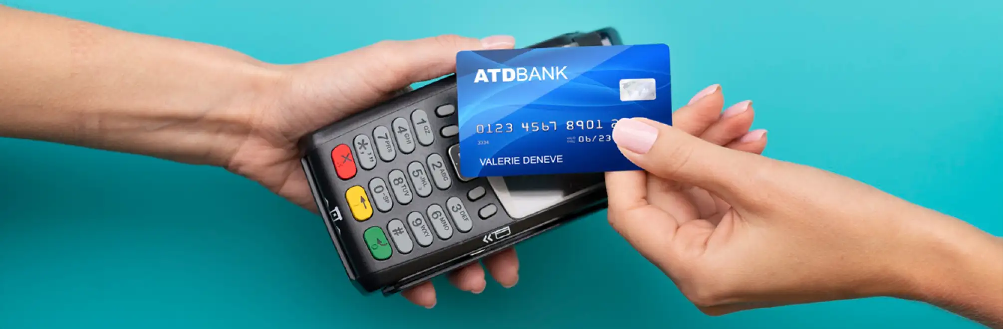 Hand holding card near payment terminal